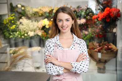 Photo of Professional female florist in apron at workplace