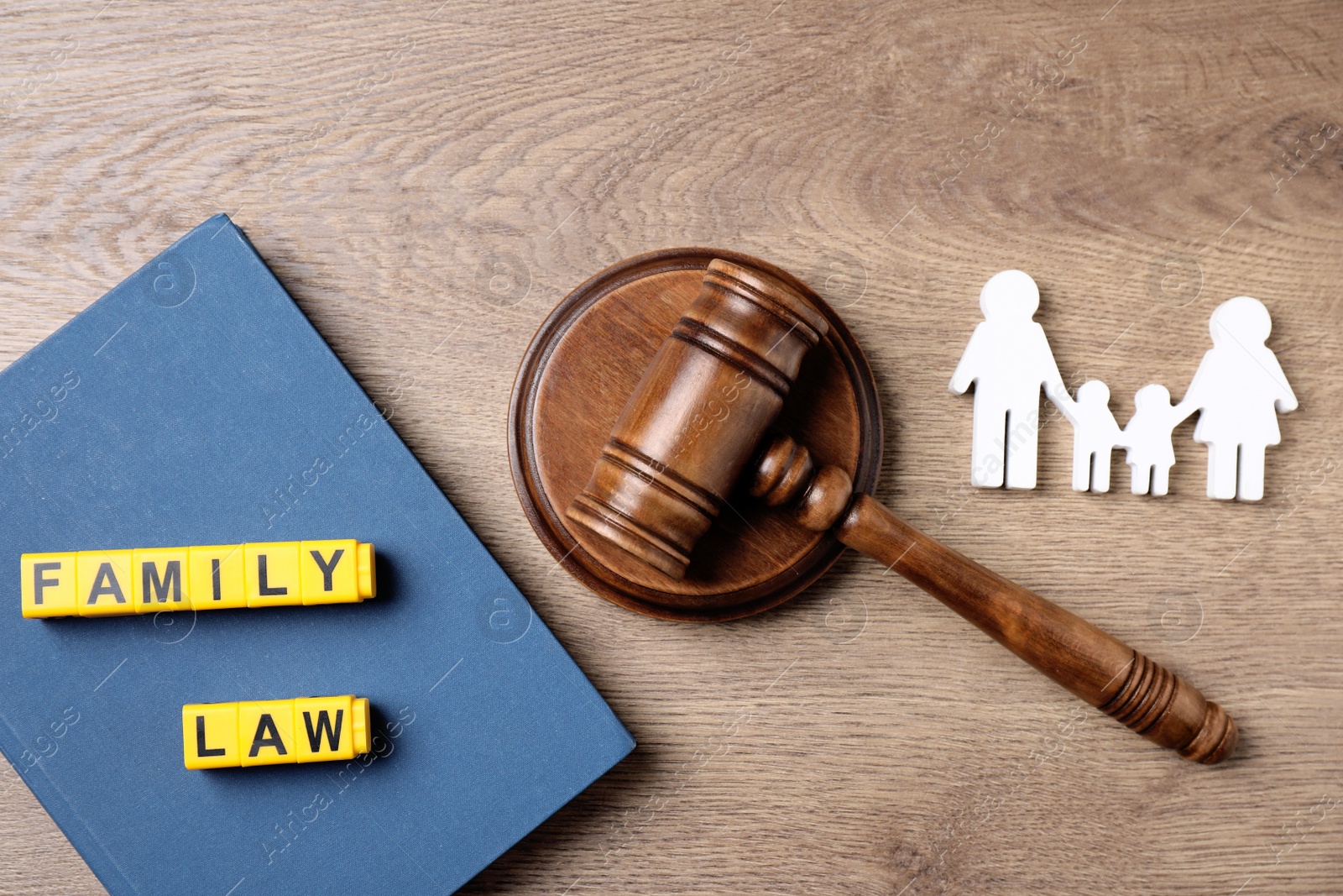 Photo of Flat lay composition with book and gavel on wooden background. Family law concept
