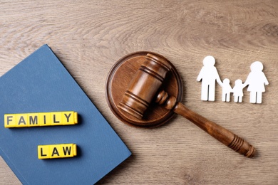 Flat lay composition with book and gavel on wooden background. Family law concept