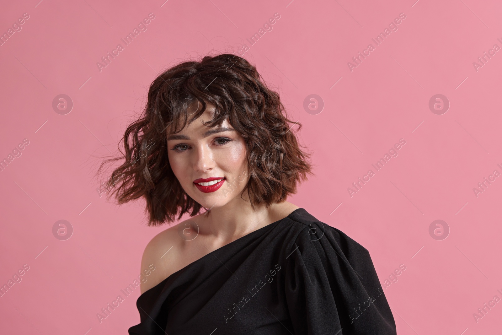 Photo of Portrait of beautiful young woman with wavy hairstyle on pink background. Space for text