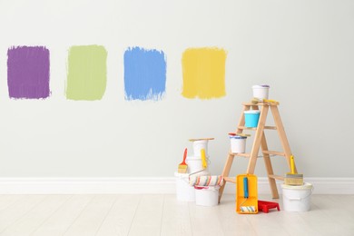 Image of Decorator's kit of tools and paints near wall indoors