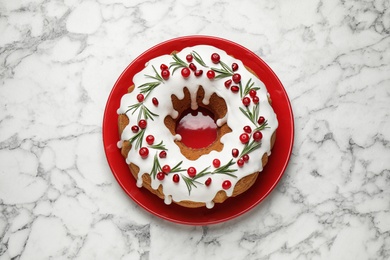 Photo of Traditional homemade Christmas cake on white marble table, top view