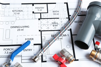Photo of Professional plumber's supplies on house plan, closeup
