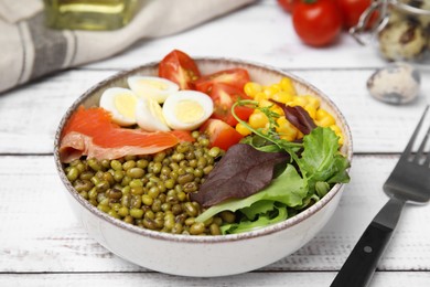 Photo of Bowl of salad with mung beans on white wooden table