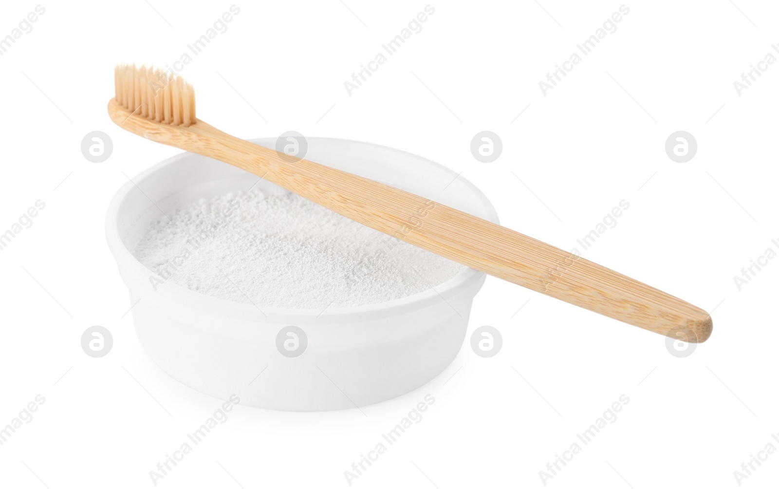 Photo of Bowl of tooth powder and brush on white background