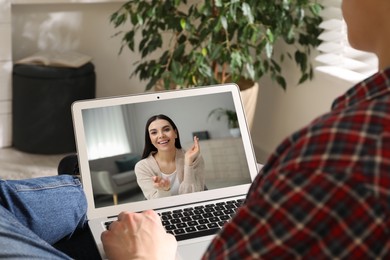Image of Man talking with beautiful woman using video chat on laptop indoors , closeup. Online dating