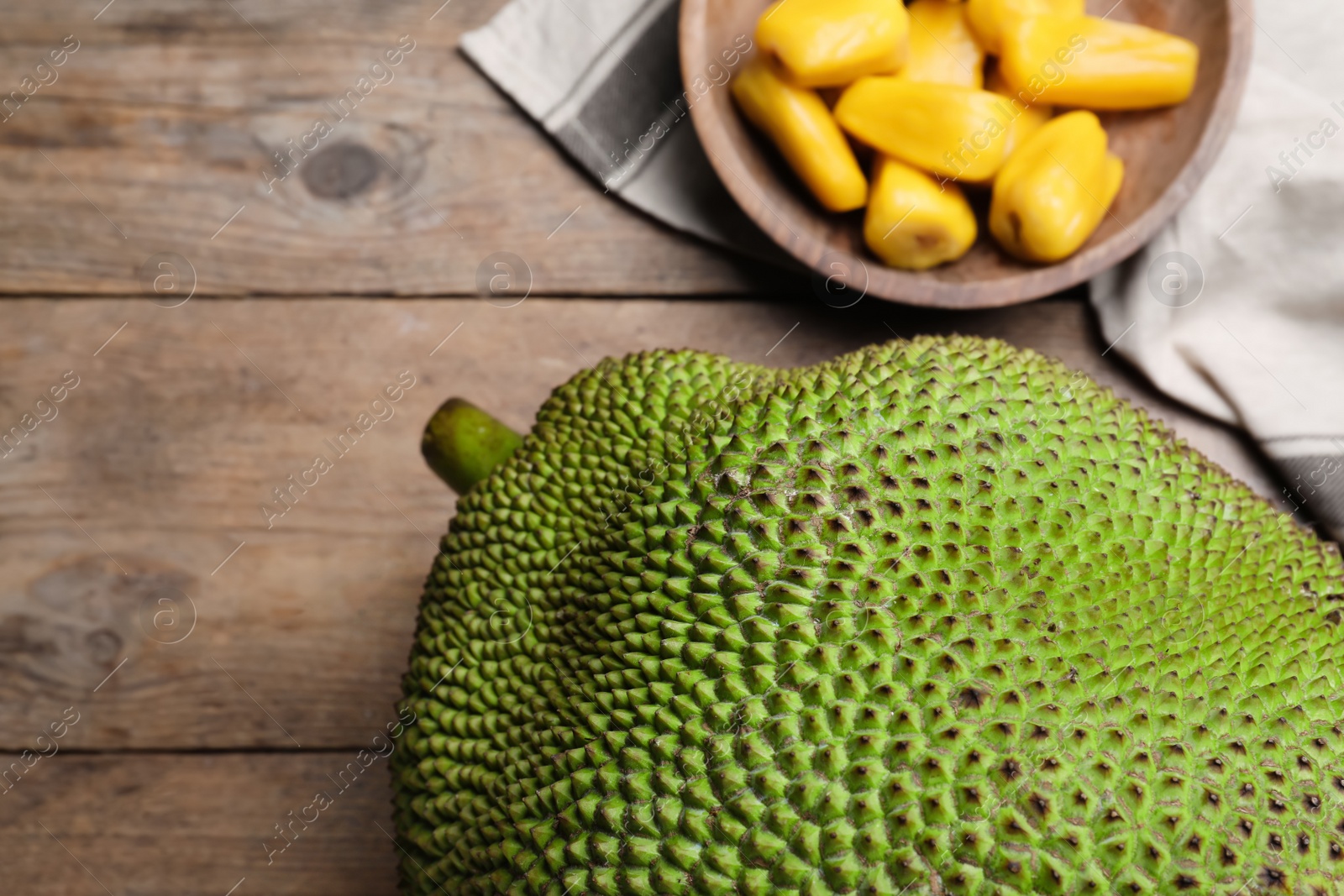 Photo of Fresh exotic jackfruit on wooden table, above view