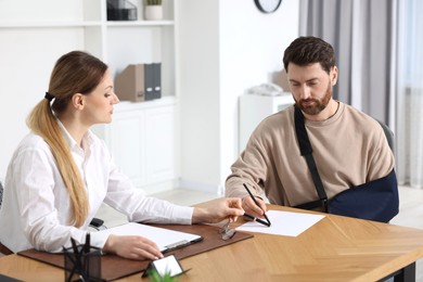 Photo of Injured woman having meeting with lawyer in office