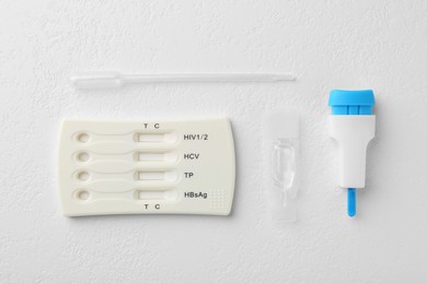Disposable multi-infection express test kit on white table, flat lay