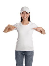 Photo of Young happy woman in cap and tshirt on white background. Mockup for design