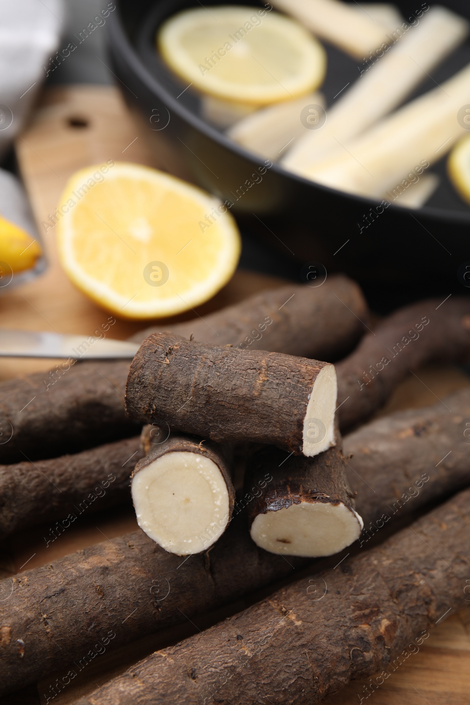 Photo of Raw salsify roots on table, closeup view