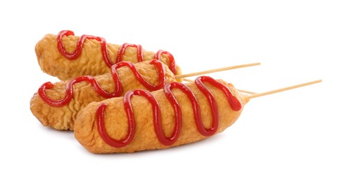 Delicious deep fried corn dogs with ketchup on white background