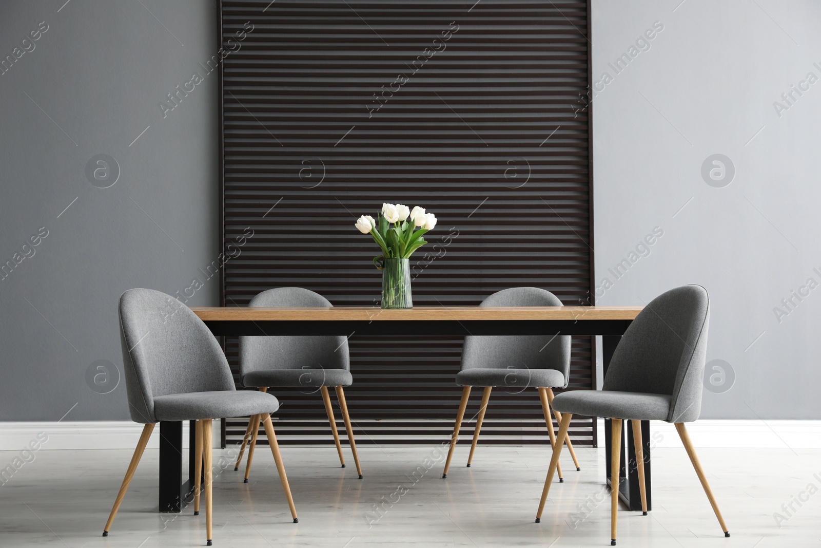 Photo of Table and chairs in room. Stylish interior design