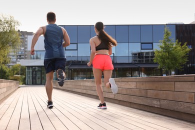 Photo of Healthy lifestyle. Couple running outdoors, low angle view