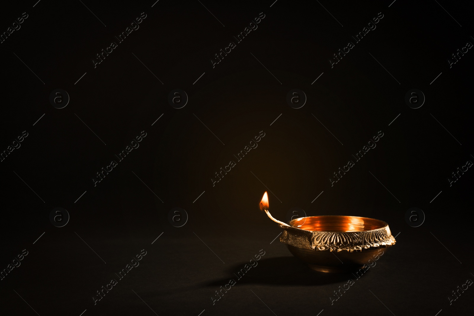 Photo of Diwali diyas or clay lamps on dark background