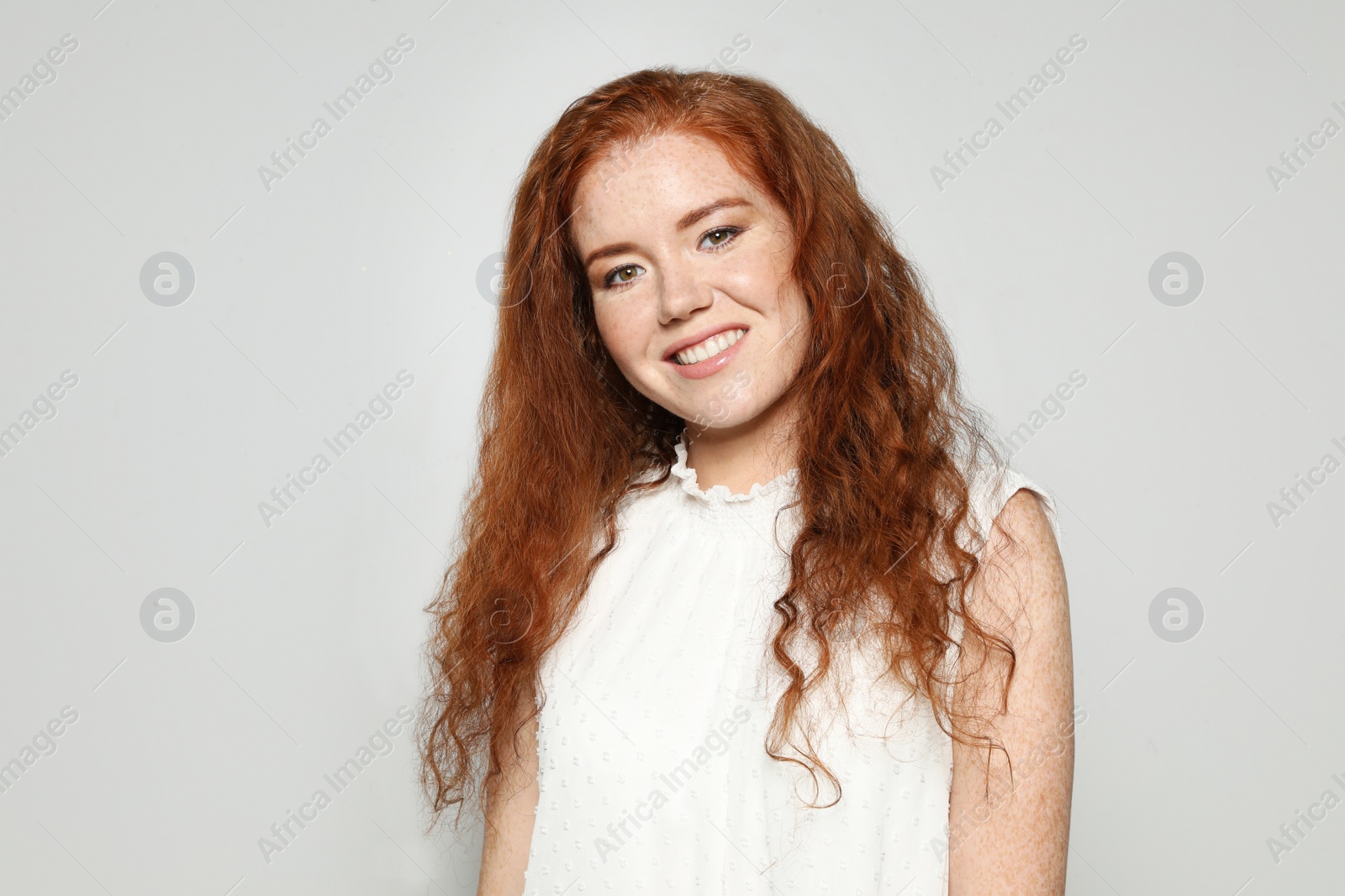 Photo of Portrait of young woman with beautiful face on grey background