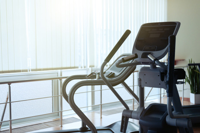 Elliptical trainer and treadmill in gym. Modern sport equipment