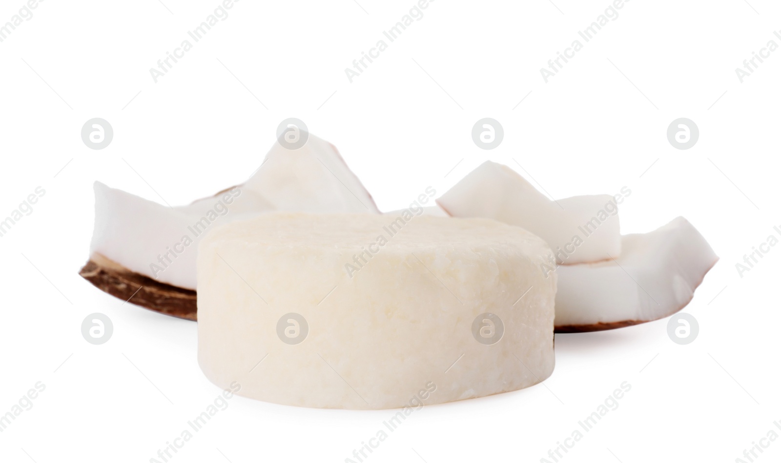 Photo of Solid shampoo bar and coconut pieces on white background. Hair care