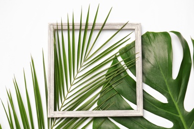 Photo of Beautiful composition with tropical leaves on light background, top view