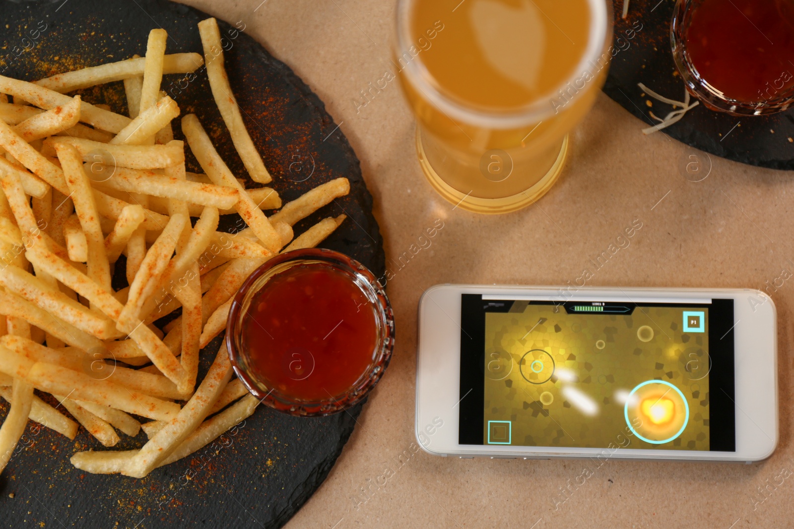 Photo of Flat lay composition with smartphone and french fries on table