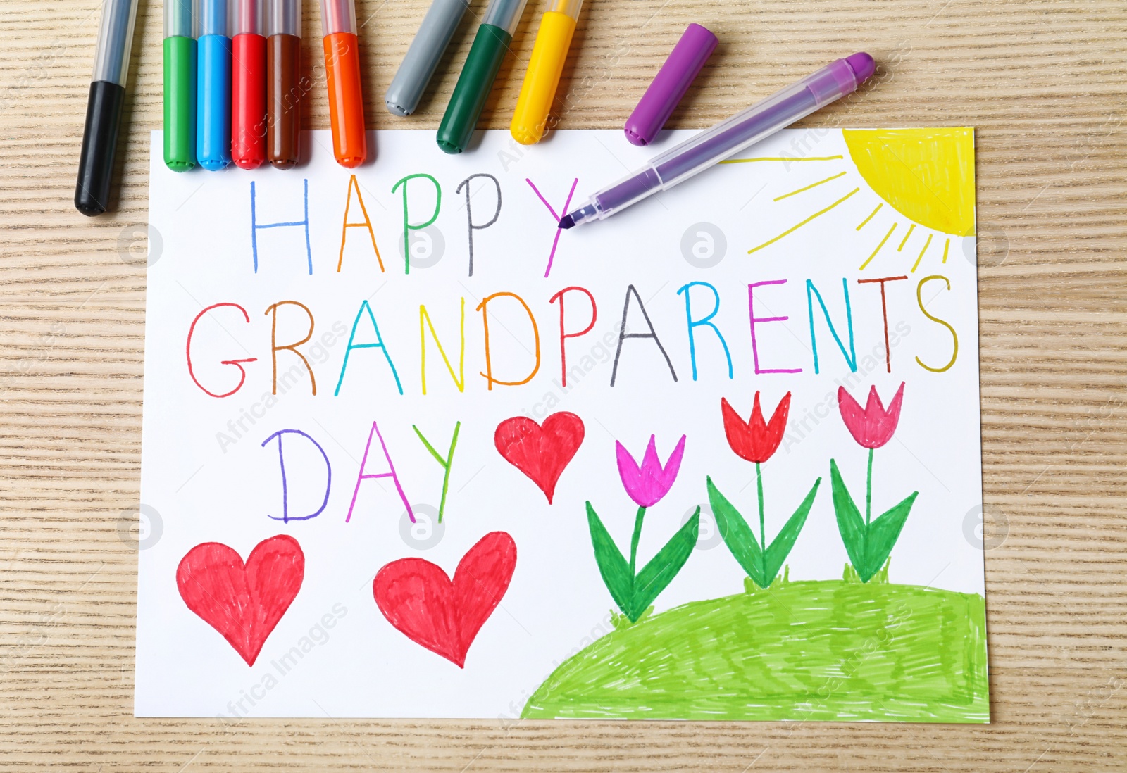 Photo of Beautiful drawing on wooden table, flat lay. Happy Grandparents Day