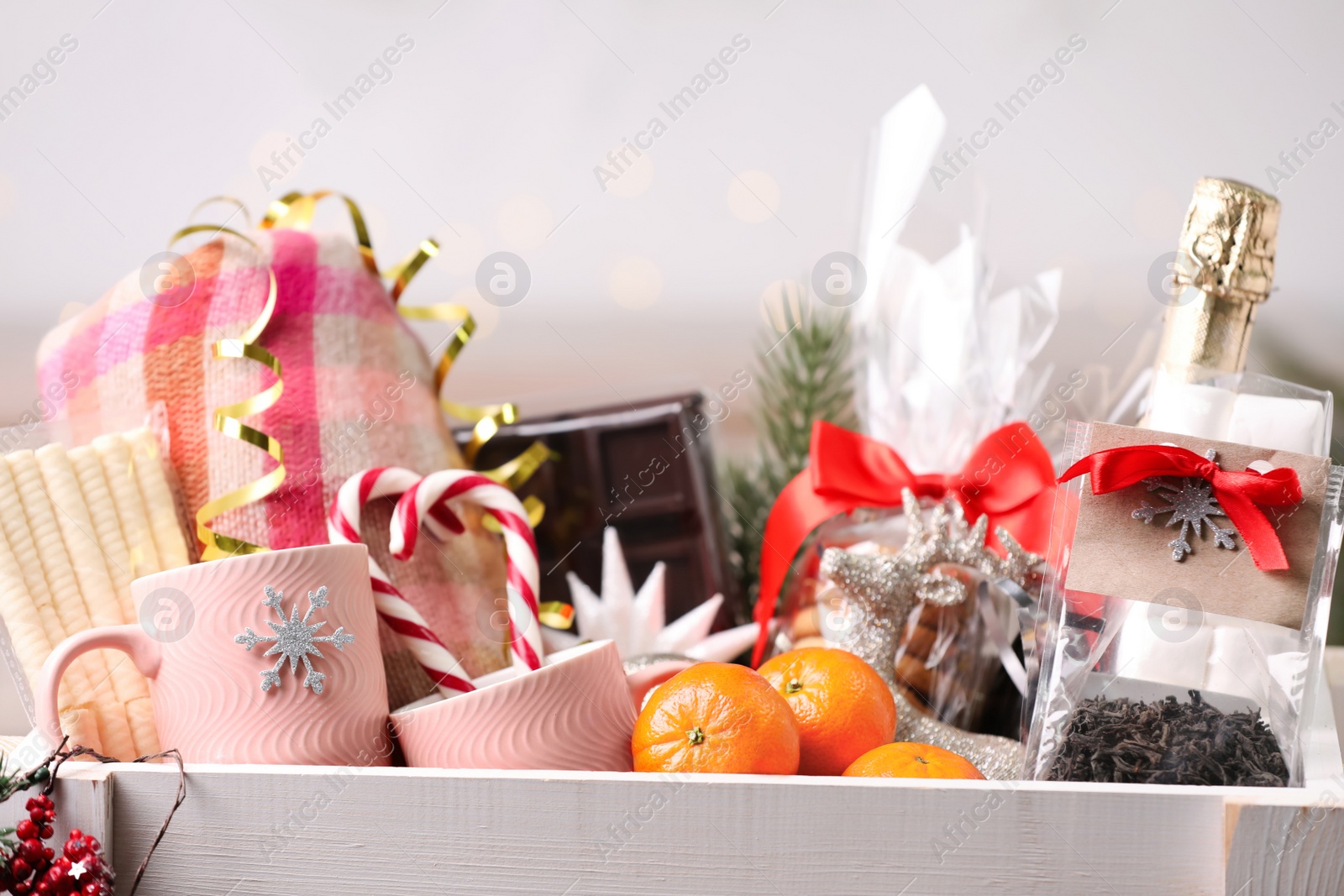 Photo of Crate with Christmas gift set on blurred background