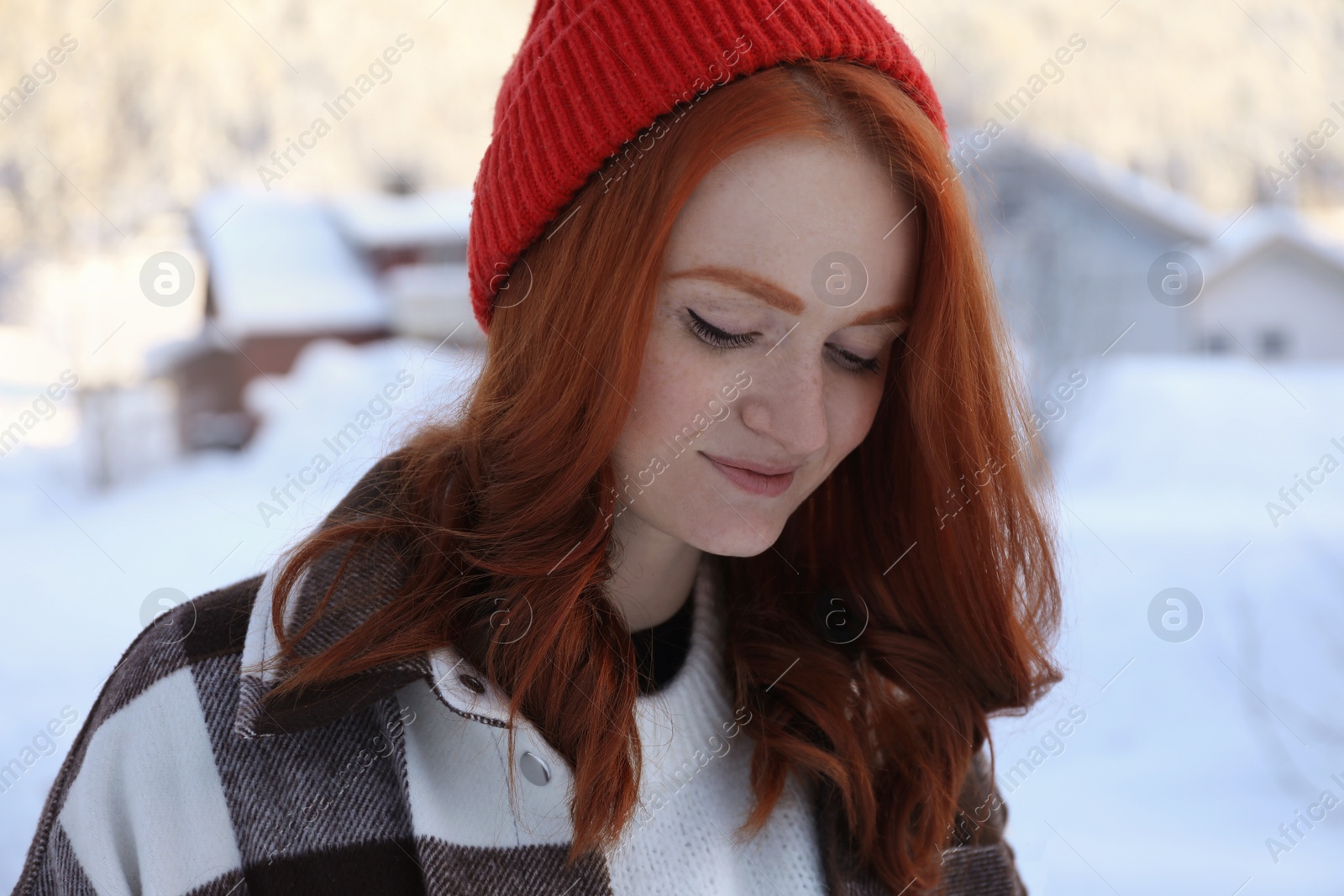 Photo of Portrait of beautiful young woman on snowy day outdoors. Winter vacation