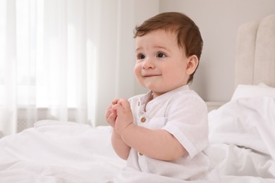 Photo of Cute baby boy on bed at home