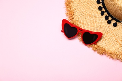Photo of Flat lay composition with heart shaped sunglasses on color background, space for text