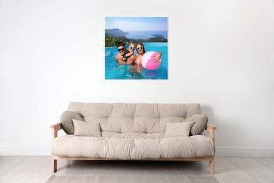 Canvas with printed photo of happy family in outdoor swimming pool on white wall in living room