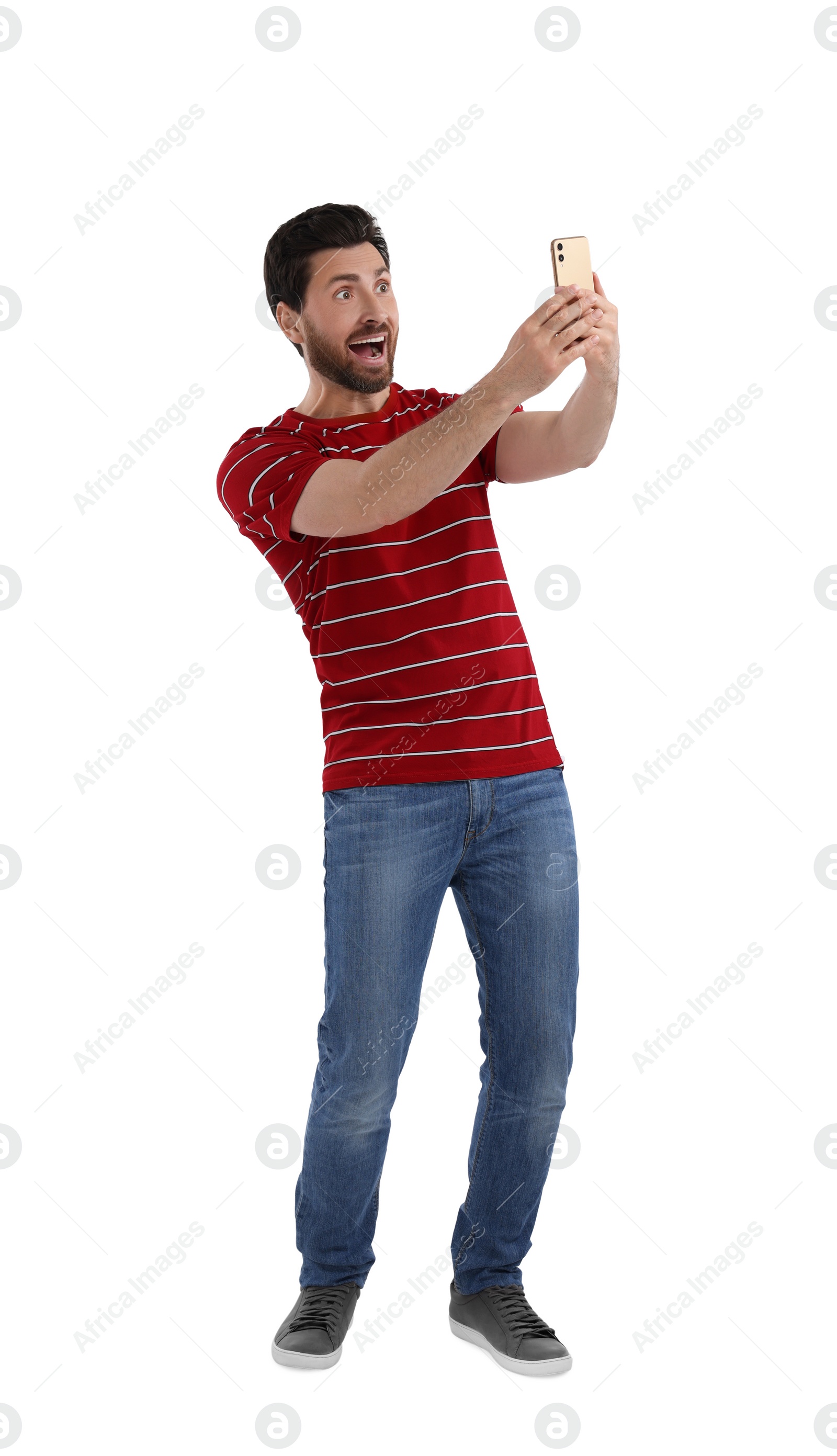 Photo of Happy man taking selfie with smartphone on white background