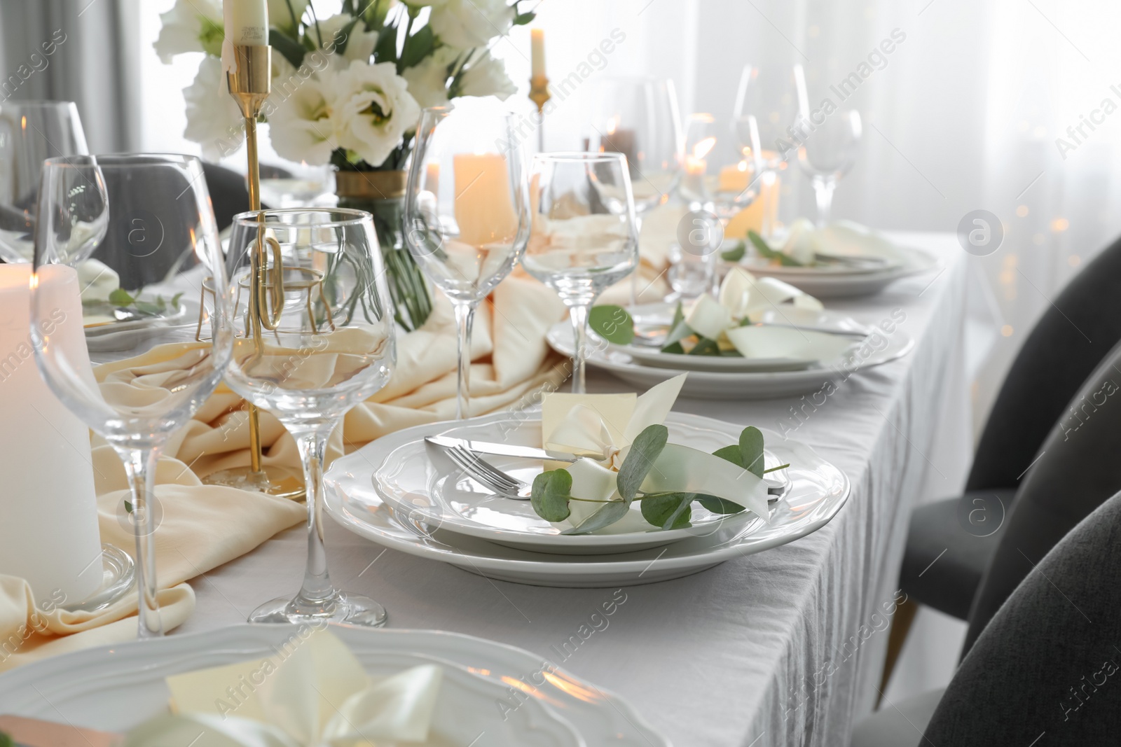 Photo of Festive table setting with beautiful floral decor in restaurant