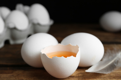 Photo of Fresh raw chicken eggs on wooden table, closeup