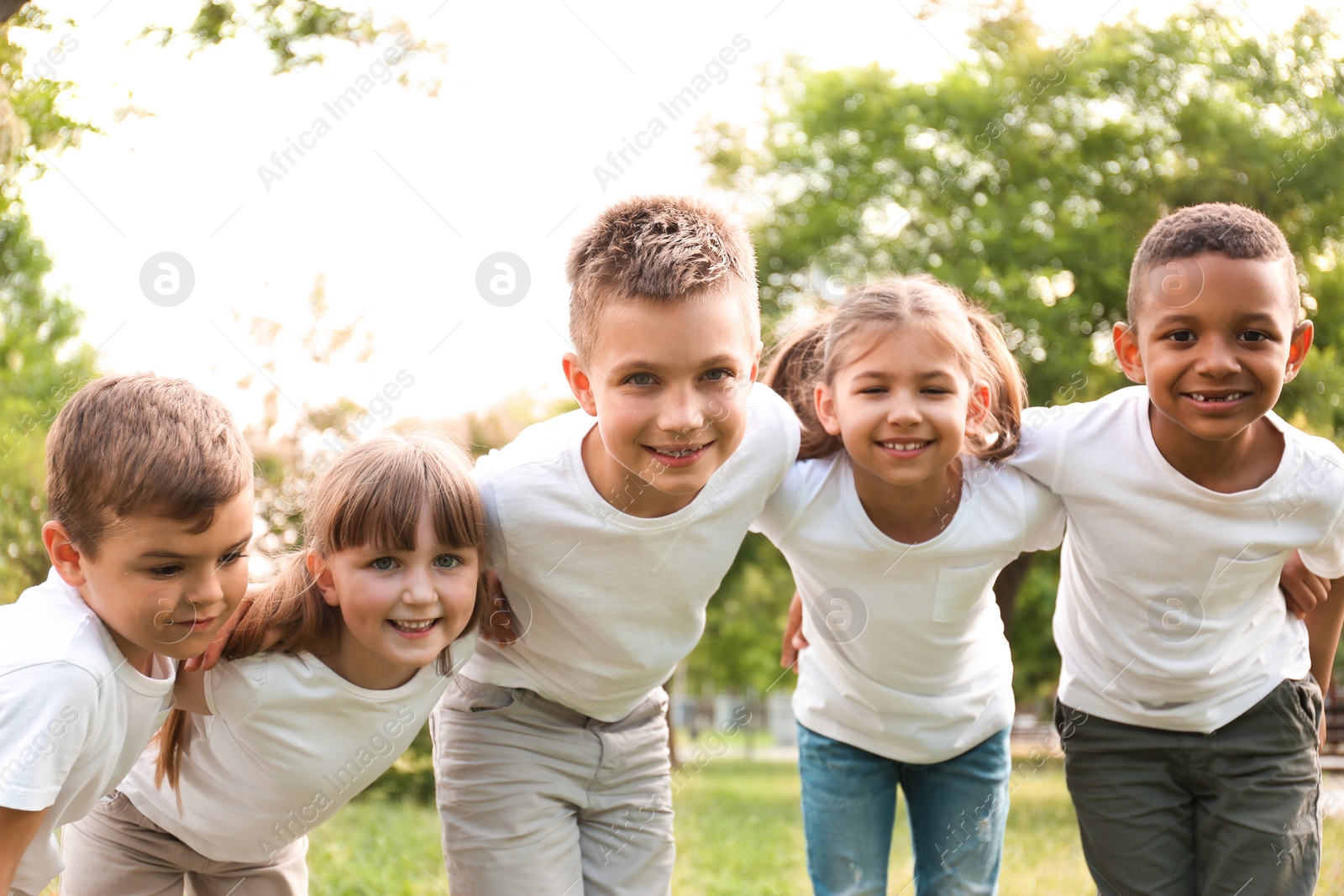 Photo of Group of children huddling in park. Volunteer project