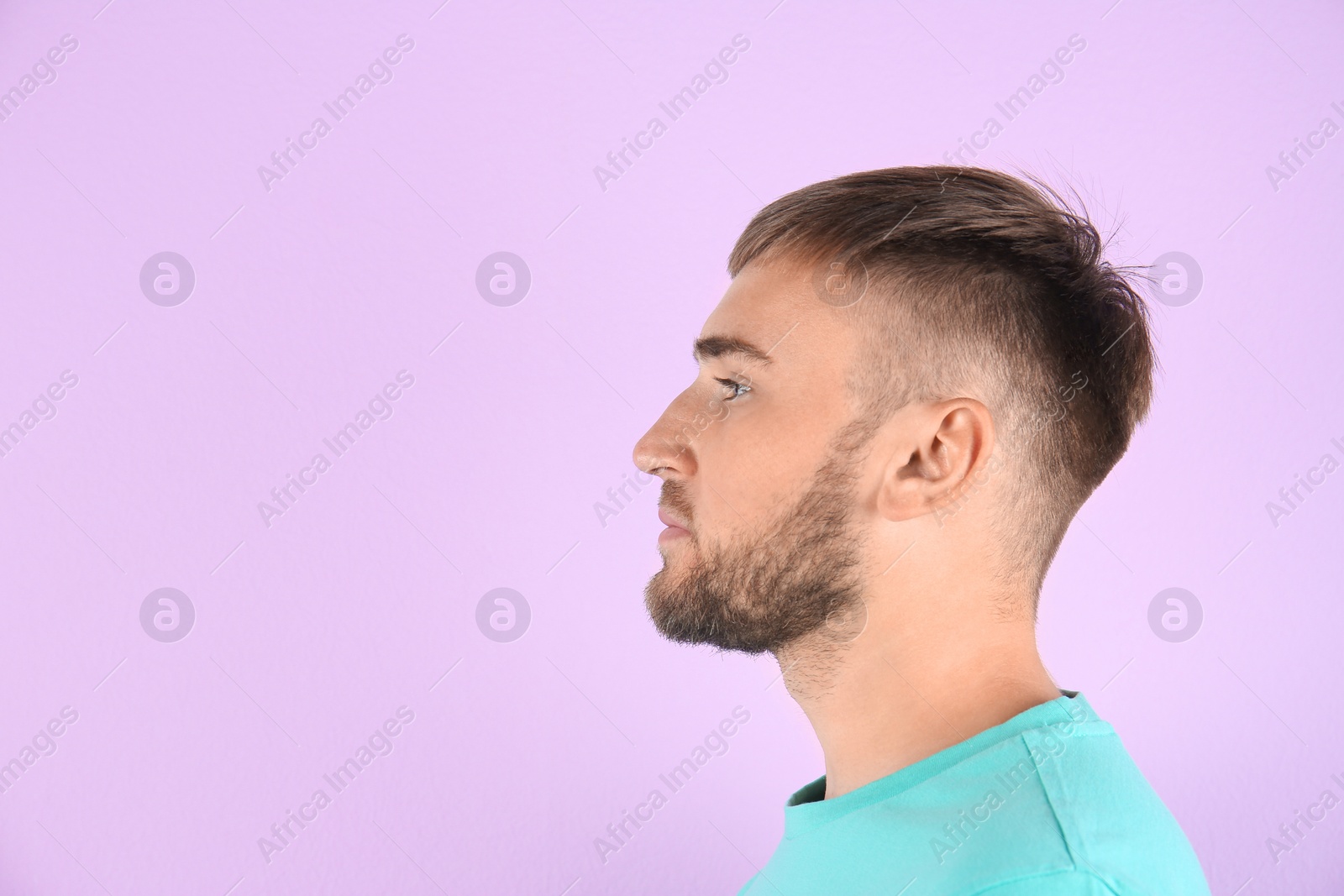 Photo of Young man on color background with copy space text. Hearing problem