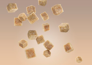 Brown cane sugar cubes falling on color gradient background