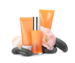 Photo of Cosmetic products, flower and spa stones on white background