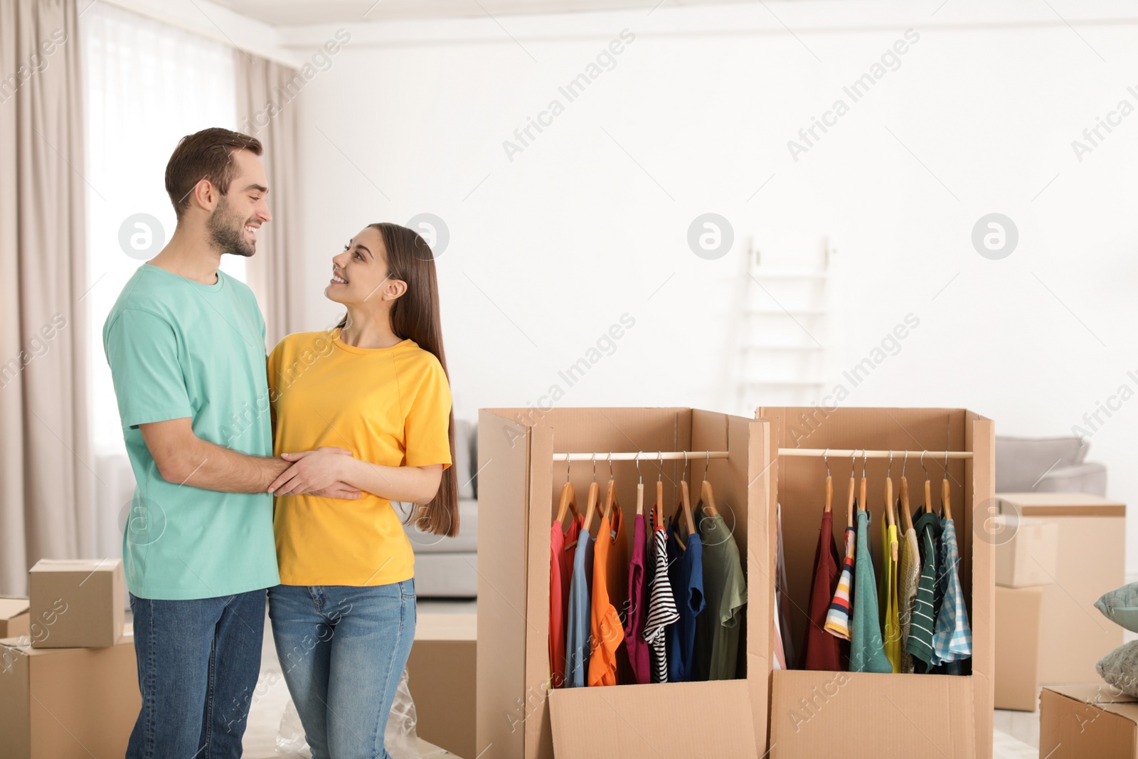 Photo of Young couple near wardrobe boxes at home