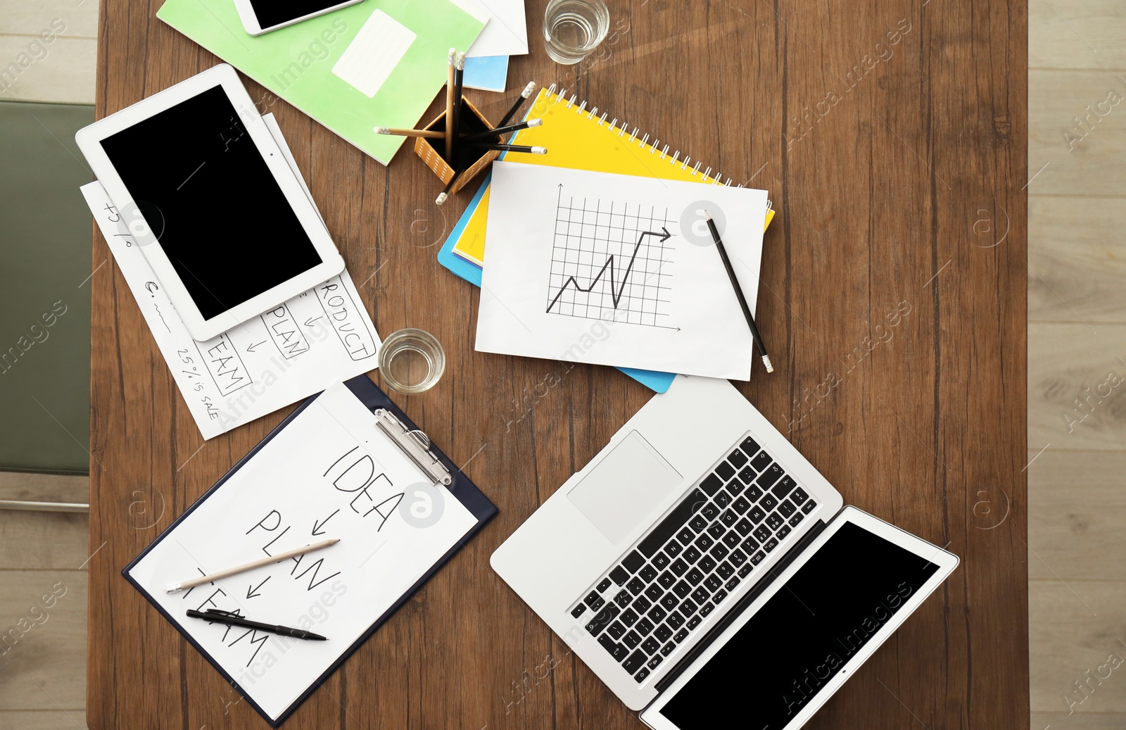 Photo of Office workplace with laptop, tablet computer and stationery, top view