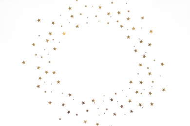 Frame made of star shaped confetti on white background, top view. Space for text