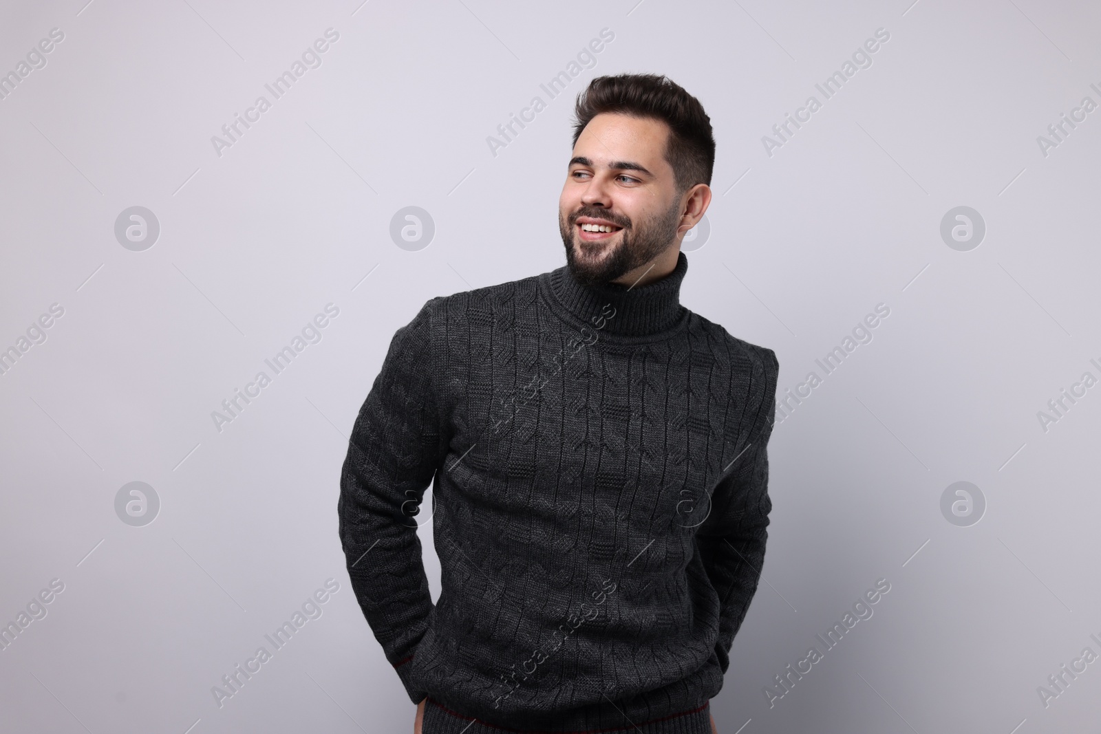 Photo of Happy man in stylish sweater on white background