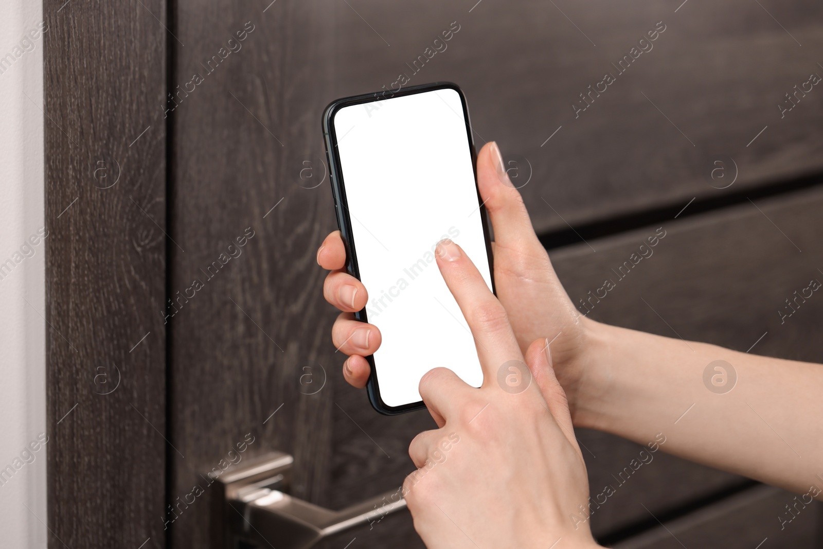 Photo of Woman unlocking door using smartphone, closeup view