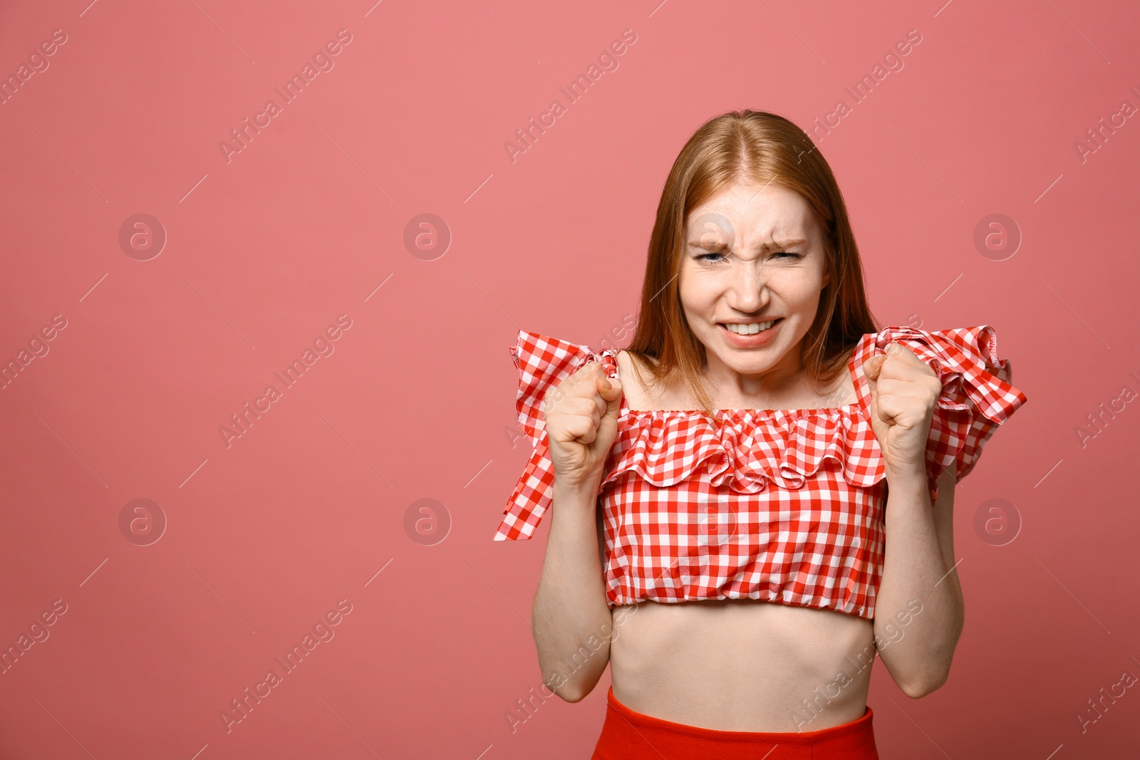 Photo of Portrait of emotional young woman on pink background, space for text