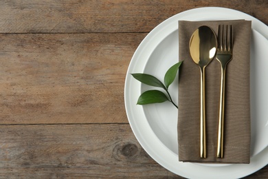 Beautiful table setting on wooden background, flat lay. Space for text