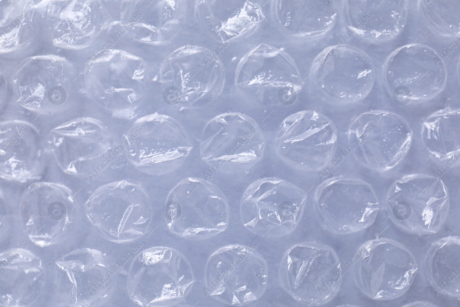 Photo of Transparent bubble wrap on gray background, top view