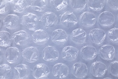 Photo of Transparent bubble wrap on gray background, top view