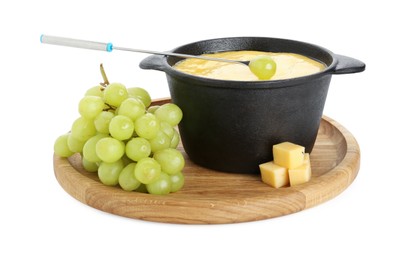 Photo of Fondue with tasty melted cheese, fork and grapes isolated on white