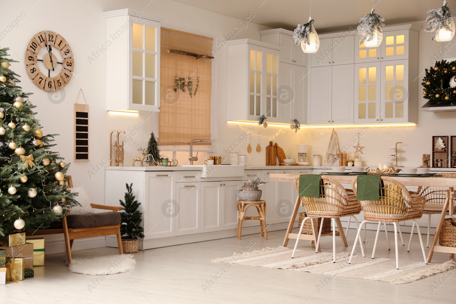 Photo of Cozy open plan kitchen decorated for Christmas. Interior design