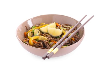 Photo of Stir-fry. Delicious cooked noodles with chicken in bowl and chopsticks isolated on white