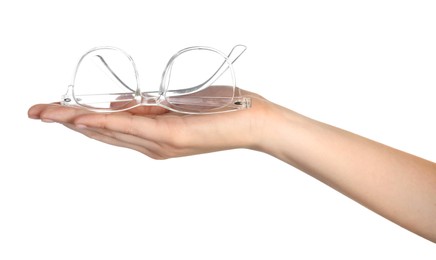 Woman holding glasses with transparent frame on white background, closeup